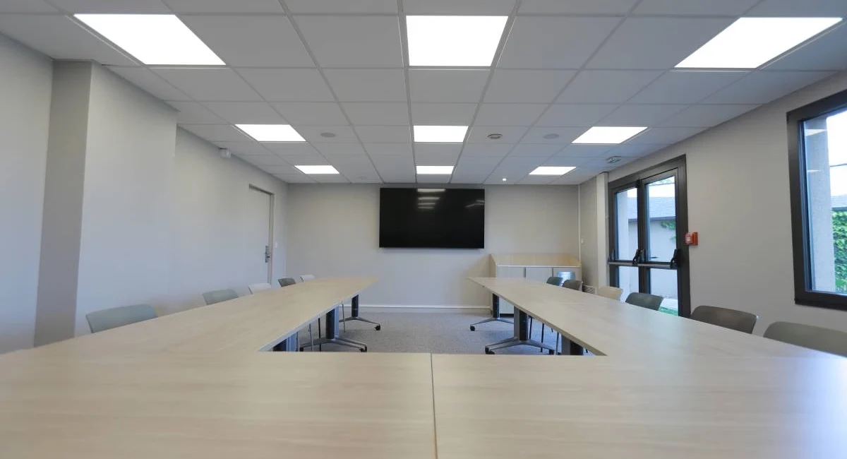 Salle de réunion de l’Hôtel Antares à Honfleur aménagée en configuration U avec écran de présentation